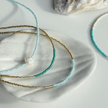 Load image into Gallery viewer, Gold and ocean blue necklaces
