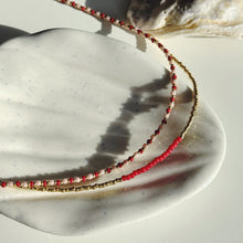 Load image into Gallery viewer, Gold glass bead necklace with ruby red accent
